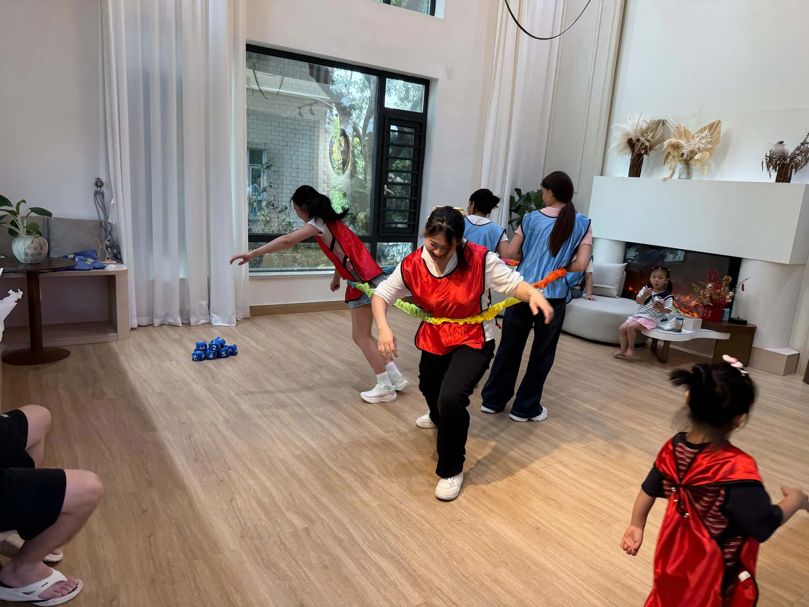 Red and blue groups taking part in the indoor elastic-band direction challenge