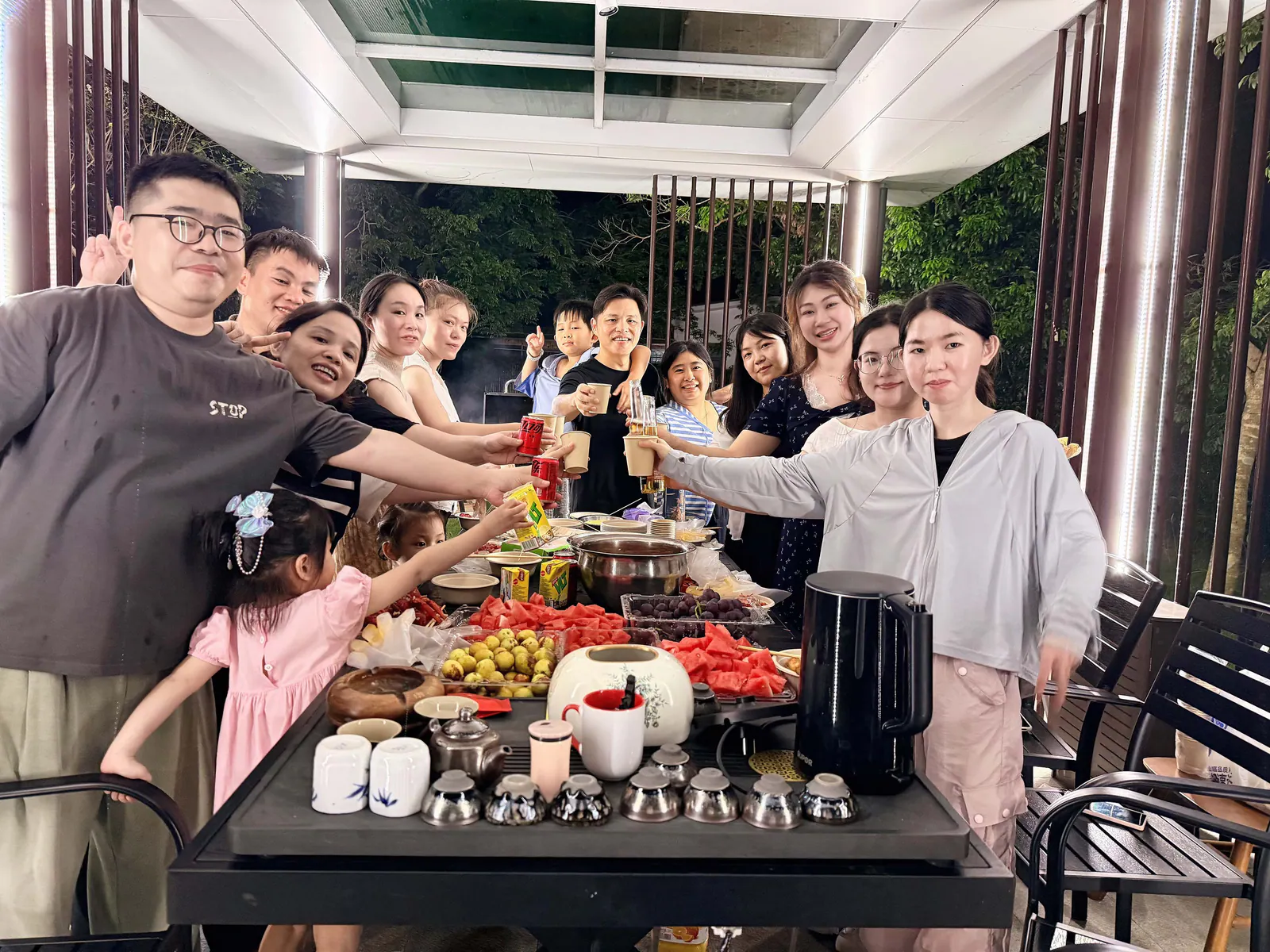 Colleagues raising their glasses around the table during the evening gathering